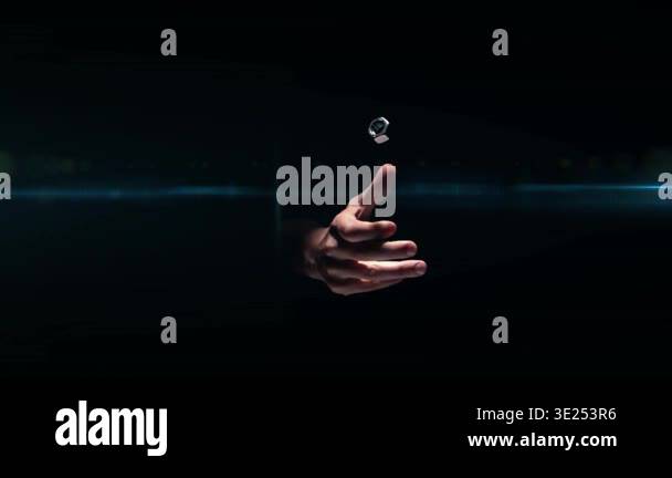 Solo hand flicking metal nut upward, object rotating while glow ring ...