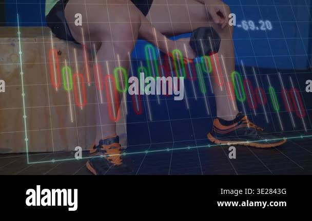 Man picking up dumbbell, doing seated biceps curls building strength ...