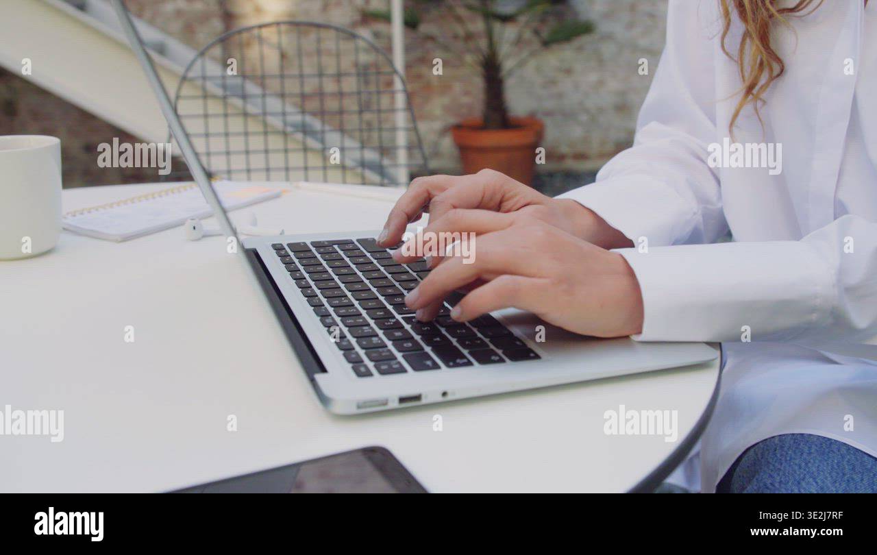 Woman with laptop in yard Stock Video Footage - Alamy