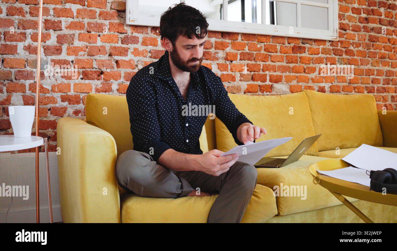Man reading notes and paperwork at home Stock Video Footage - Alamy