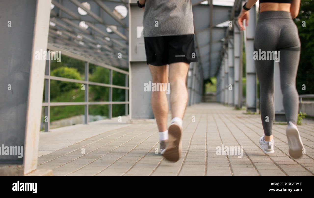 Jogging Track Railing Back view of sport couple running along railing in stadium Stock Video ...
