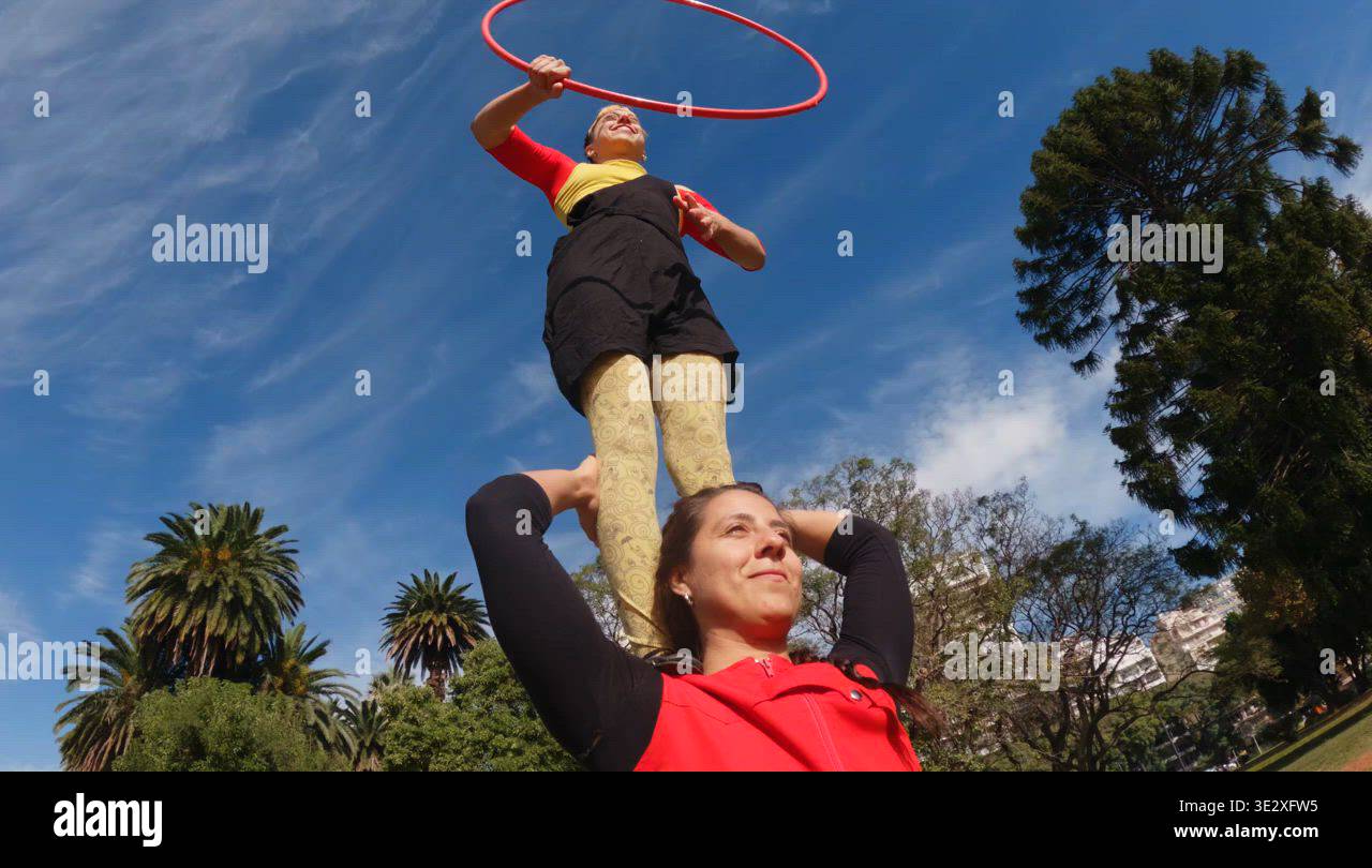 Performer Balances on Another Person While Hula Hooping Outdoors Stock ...