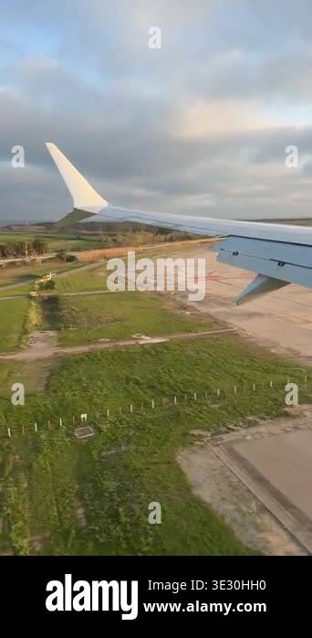 Passengers point of view from an airplane window showing the wing and ...
