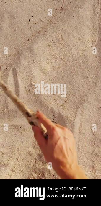 Vertical video. Hand Writing Word Love with Heart Symbol in Sand on ...