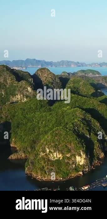 Aerial view of lush green limestone islands rising from the blue sea ...