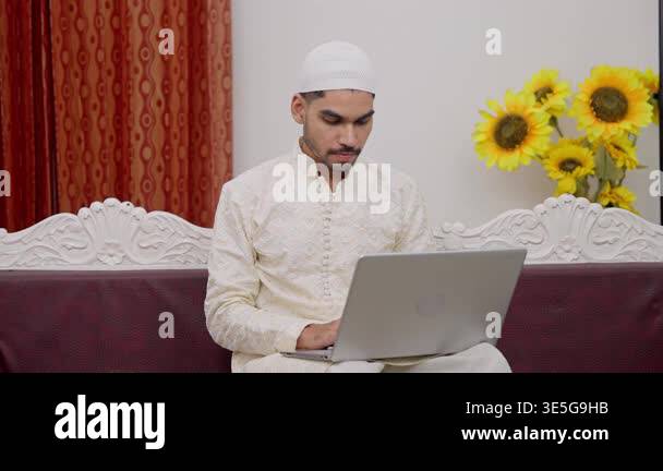 Seriouse Muslim Man Working on Laptop and Writing Notes in Notebook ...
