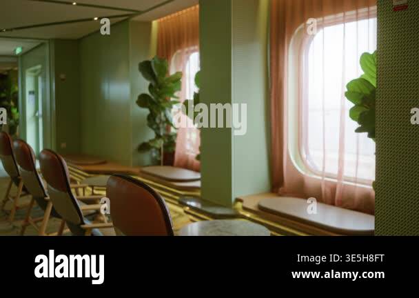 Luxury bar interior with soft blurred window seating, leather chairs ...
