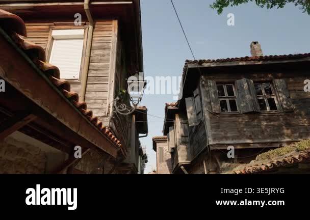 Old wooden houses with tiled roofs and shutters in historic Nessebar ...