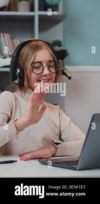 Smart caucasian kid girl wearing headphones waving hand talking with ...
