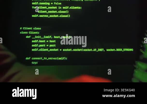 Hooded anonymous hacker hacking on laptop in dark environment with ...