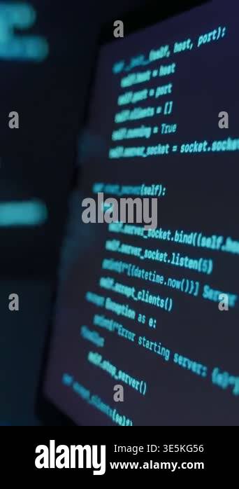 Laptop with code on screen placed on desk in dark workspace, with blue ...