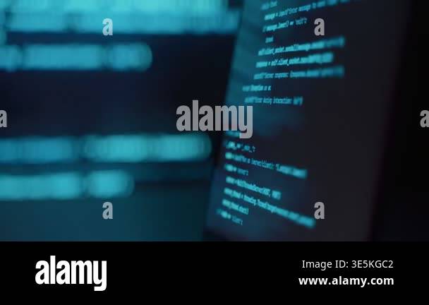 Laptop on table in dark technology environment with blue programming ...