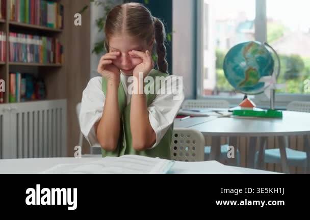 Unhappy sad Caucasian little girl child kid schoolgirl crying at school ...
