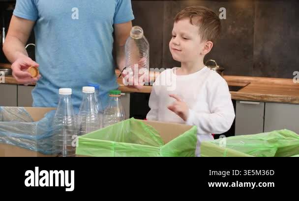 Father removes cap from plastic bottle passing container to preschooler ...