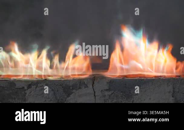 Dynamic fire flames burning with smoke creating an abstract background ...
