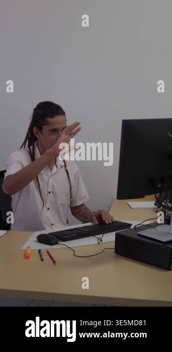 Hispanic man with dreadlocks on a video conference call, waving and ...