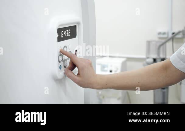 Control Panel Scan Button Medical professional pressing buttons on CT scanner control panel in ...