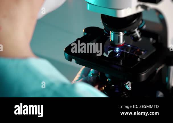 Close up of scientist working with microscope analyzing sample in ...