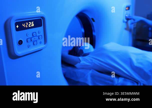 Close up of MRI scanner control panel with patient inside during ...