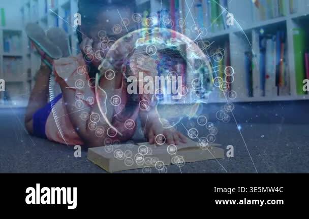 Student lying on library floor tapping tablet creating rotating globe ...