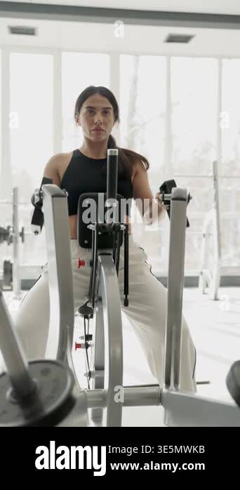 Woman training on rowing machine demonstrating strength endurance and ...