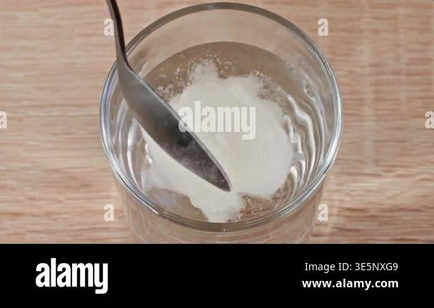 Close-up Adding Collagen Powder Into Glass Of Water, Start Of ...