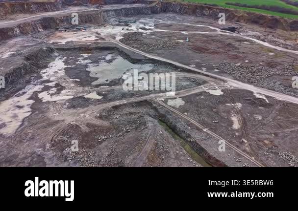 Rock Query Granite quarry site features large open pits, machines working on the ...
