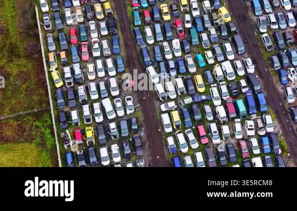 A large area filled with numerous parked cars in different colors and ...