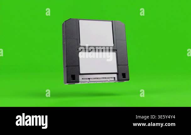 A vintage floppy disk floats in front of a vibrant green screen ...