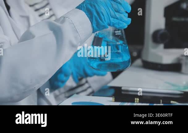 scientist in laboratory. scientist working with test tubes and ...