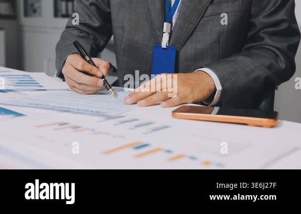 business man working on financial documents and computer on the table ...