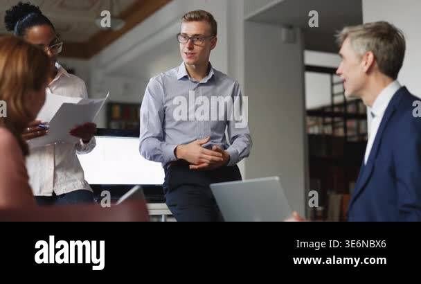 Inform Leader Team leader conducting group briefing with multiethnic teammates in ...
