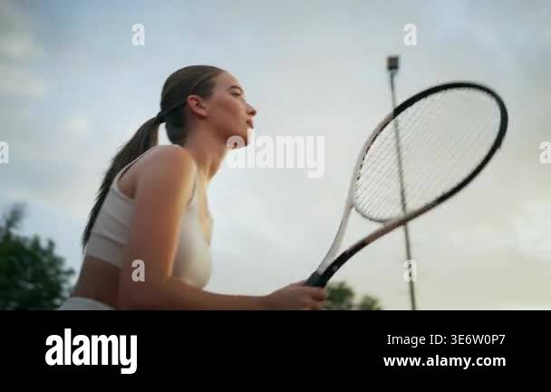 White Woman Tennis Player Practicing Serve At Dusk On Outdoor Court ...