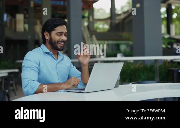 Portrait of happy Indian man using sign language on city street. Joyful ...