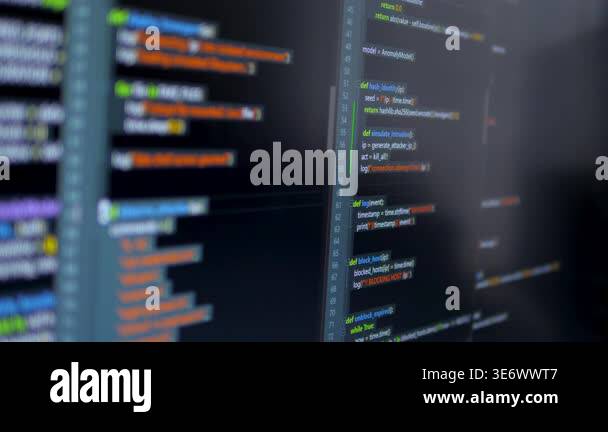 Close up computer monitors displaying fictional programming code and ...