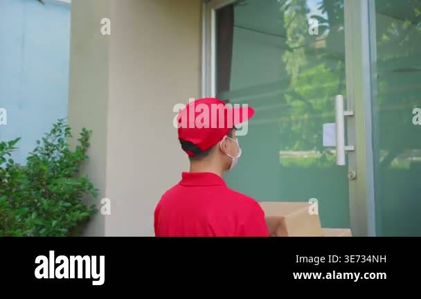 Delivery person wearing red cap holding box Stock Video Footage - Alamy