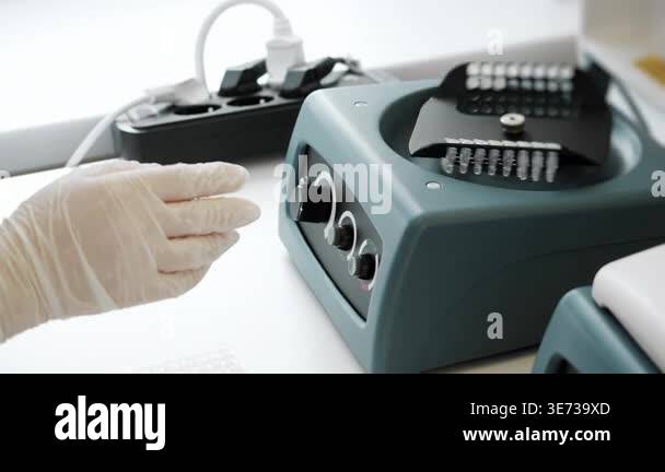 Lab Tube Processing Lab technician opening laboratory mixer and removing test tubes during ...