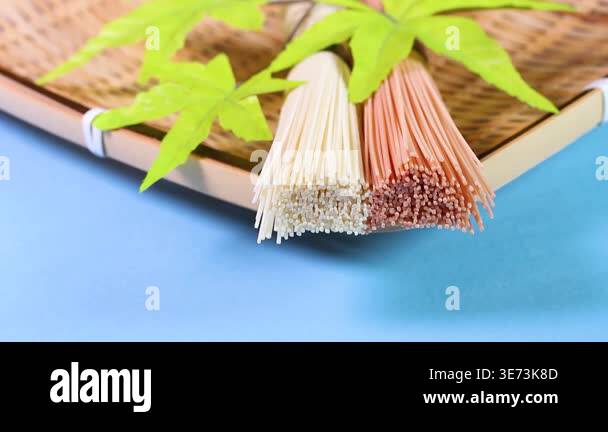 Colorful vegetable somen noodles on a bamboo strainer rotating against ...