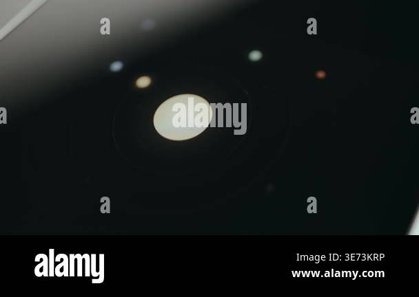 A large bright central disk with smaller dots orbiting, graphic ...