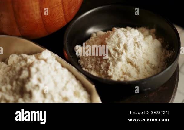 A person measures flour using a scoop and shows how to prepare it for ...