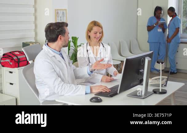 Medical team of doctors and nurses working together in a bright ...