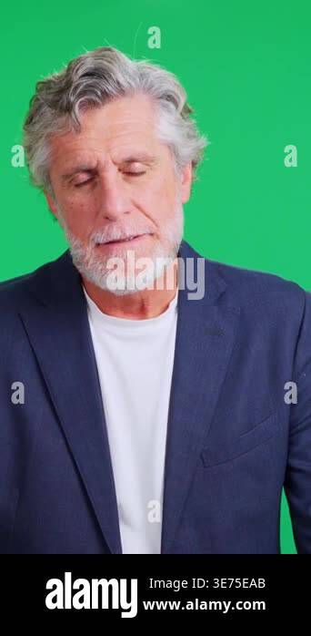 Senior man with a beard feeling displeased against a chroma key ...