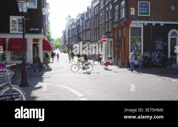 Street scene in amsterdam featuring blurred pedestrians and bicycles ...