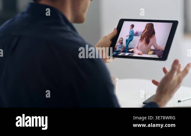 Husband video calling wife by tablet web chat close up. Shoulder view ...