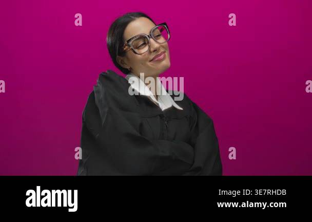 Hispanic woman in a black robe stands confidently against a vibrant ...