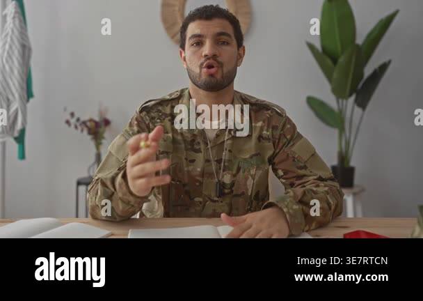 Man in military uniform with dog tags holds yellow pen and writes in ...