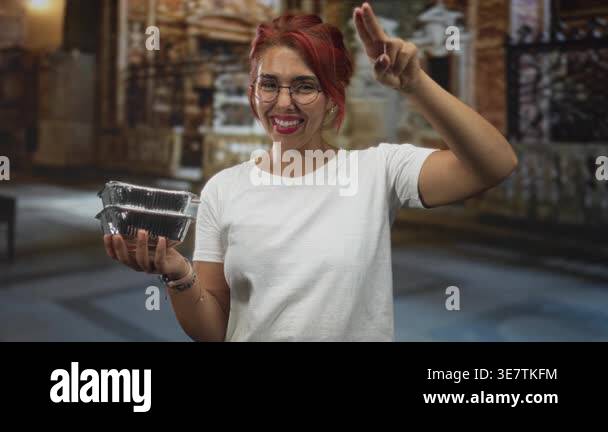 Woman holding foil food containers and saluting with hand to forehead ...