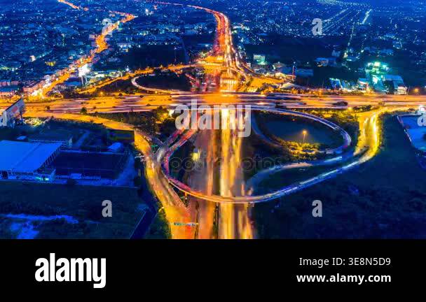Timelapse aerial view of cityscape and traffic on highway at night. 4K ...