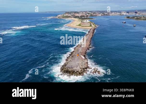 Aerial drone video flying over Nobbys Breakwall towards Nobbys ...