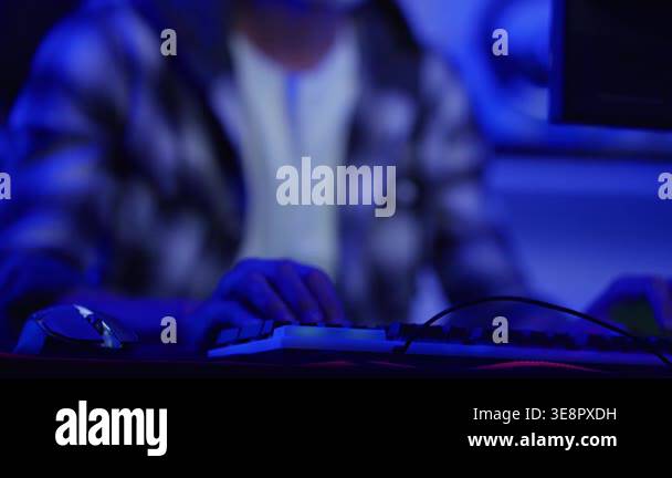 Person typing on keyboard in blue light Stock Video Footage - Alamy